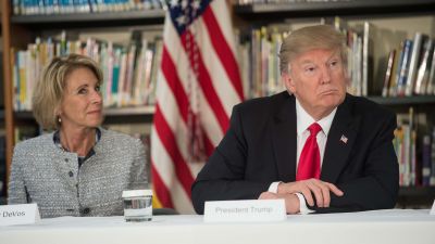 President Donald Trump and Education Secretary Betsy DeVos listen during a meeting with parents and teachers at Saint Andrew Catholic School in Orlando, Florida, on March 3, 2017. (Photo by Nicholas Kamm/AFP/Getty Images)
