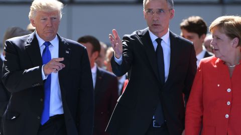 NATO Secretary General Jens Stoltenberg speaks with US President Donald Trump and German Chancellor Angela Merkel as they arrive for the unveiling ceremony of the Berlin Wall monument during the NATO summit in Brussels on May 25, 2017. (Photo by Emmanuel Dunand/AFP/Getty Images)