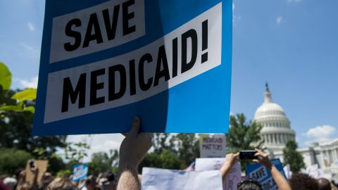 Participants hold signs during the Senate Democrats' rally against Medicaid cuts in front of the US Capitol on June 6, 2017. (Photo By Bill Clark/CQ Roll Call)