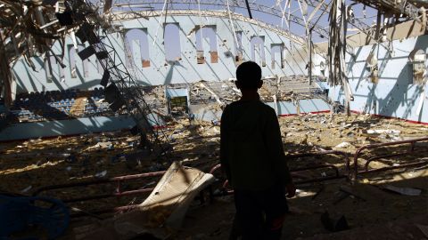 A Yemeni boy inspects the damage at a sports hall that was partially destroyed by Saudi-led air strikes in the Yemeni capital Sana'a on Jan. 19, 2016. (Photo by Mohammad Huwais/AFP/Getty Images)