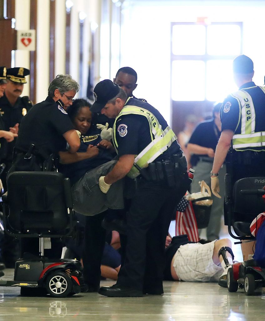 Police remove protesters from in front of the office of Senate Majority Leader Mitch McConnell (R-KY) inside the Russell Senate Office Building in Washington, DC on June 22, 2017. Members of a group with disabilities were protesting the proposed GOP health care plan. (Photo by Mark Wilson/Getty Images)