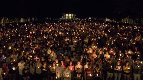 Thousands gather with candles to march along the path that white supremacists took the prior Friday with torches on the University of Virginia Campus in Charlottesville, Virginia on Aug. 16, 2017. (Photo by Samuel Corum/Anadolu Agency/Getty Images)