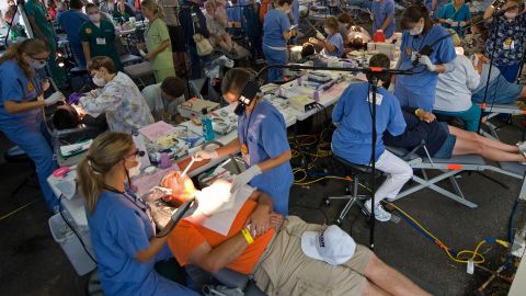 Hundreds of dentists and support staff work on patients inside the Virginia-Kentucky Fairgrounds in Wise, Virginia, on July 24, 2009 during the Remote Area Medical (RAM) Expedition. Close to 600 doctors and support staff volunteer their time for free treatment to individuals who have difficulty getting health care. (Photo by Paul J. Richards/AFP/Getty Images)