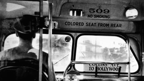 View from behind the back of a bus driver, with a sign on the front of the vehicle that reads "Colored seat from rear," Miami, Florida, circa 1955. (Photo by Tony Vaccaro/Getty Images)