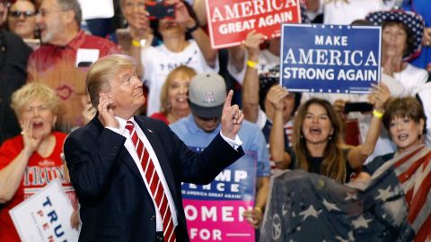 President Donald Trump gestures to the crowd of supporters at the Phoenix Convention Center as he takes the stage during a rally on Aug. 22, 2017. (Photo by Ralph Freso/Getty Images)