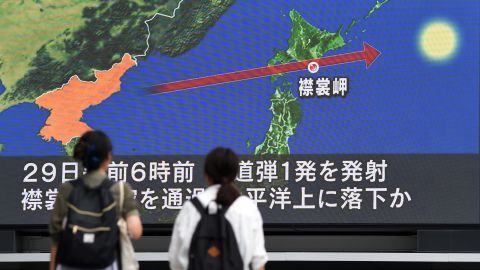 Pedestrians watch the news on a huge screen displaying a map of Japan and the Korean peninsula in Tokyo on Aug. 29, 2017, following a North Korean missile test that passed over Japan. (Photo by Toshifumi Kitamura/AFP/Getty Images)