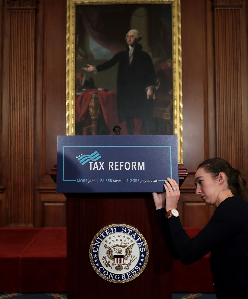 A staff member sets the stage before a news conference where Republican lawmakers announced their plans for tax reform on Sept. 27, 2017 in Washington, DC. (Photo by Drew Angerer/Getty Images)