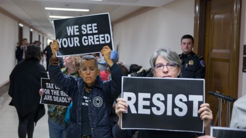 Protesters demonstrate near the full Senate Budget Committee markup of the tax reform legislation on Capitol Hill on Nov. 28, 2017 in Washington, DC. Republicans in the Senate hope to pass their legislation this week and work with the House of Representatives to get a bill to President Donald Trump before Christmas. (Photo by Tasos Katopodis/Getty Images)
