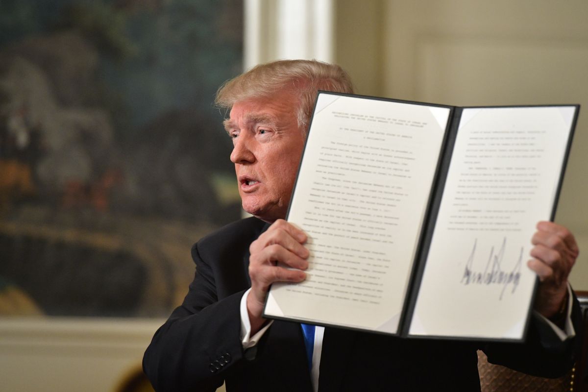 US President Donald Trump holds up a signed proclamation after he delivered a statement on Jerusalem from the Diplomatic Reception Room of the White House in Washington, DC on December 6, 2017. (Photo credit should read Mandel Ngan/AFP/Getty Images)