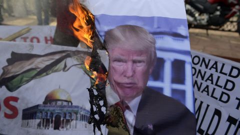 Indonesian demonstrators burn a photo featuring US President Donald Trump during a protest against his recognition of Jerusalem as the capital of Israel, in Banda Aceh on Dec. 10, 2017. (Photo by Chaideer Mahyuddin/AFP/Getty Images)