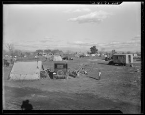 Hooverville of Bakersfield, California in April 1936 — a rapidly growing community of people living rent-free on the edge of the town dump in whatever kind of shelter available. Approximately 1,000 people lived here with their children. (Photo by Dorthea Lange, retrieved from the Library of Congress)
