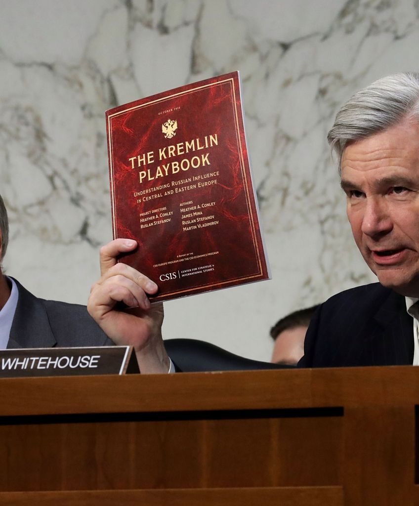 Senate Judiciary Committee member Sen. Sheldon Whitehouse (D-RI) holds up a copy of 'The Kremlin Playbook' while delivering remarks with Sen. Lindsey Graham (R-SC) (L) at the conclusion of a subcommittee hearing on Russian interference in the 2016 election in the Hart Senate Office Building on Capitol Hill May 8, 2017 in Washington, DC. (Photo by Chip Somodevilla/Getty Images)