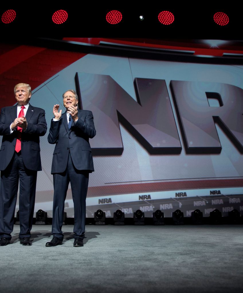 President Donald Trump stands with National Rifle Association (NRA) President Wayne LaPierre (R) and NRA-ILA Executive Director Chris Cox (L) during the NRA Leadership Forum in Atlanta, Georgia on April 28, 2017. (Photo by Jim Watson/AFP/Getty Images)