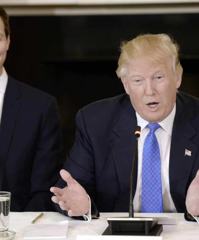 President Donald Trump speaks while Jared Kushner, senior White House advisor, left, smiles during a meeting with manufacturing executives in the State Dining Room of the White House in Washington, DC, on Thursday, Feb. 23, 2017. (Photo by Olivier Douliery/Bloomberg via Getty Images)