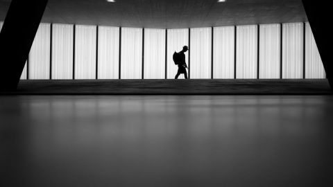 Person walking alone in a hallway