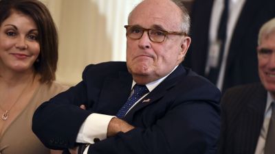 In this file photo Lawyer of the US president Rudy Giuliani looks on before the US president announces his Supreme Court nominee in the East Room of the White House on July 9, 2018 in Washington, DC. - Apparent admissions by Donald Trump's lawyer that the president negotiated a Moscow property deal all through the 2016 election, and that aides may have colluded with Russia, have Washington asking: is Rudy Giuliani going to save Trump or get him impeached? Giuliani, who last year claimed that "truth isn't truth" to explain why Trump shouldn't testify to Special Counsel Robert Mueller's Russia meddling investigation, has confounded political and legal analysts. And his most recent spate of comments to journalists -- some of which gave rise to suspicions of "drunk texting" -- have reportedly frayed his support in the White House. (Photo by SAUL LOEB / AFP) (Photo credit should read SAUL LOEB/AFP via Getty Images)