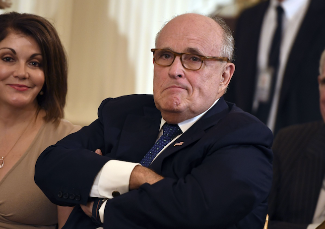 In this file photo Lawyer of the US president Rudy Giuliani looks on before the US president announces his Supreme Court nominee in the East Room of the White House on July 9, 2018 in Washington, DC. - Apparent admissions by Donald Trump's lawyer that the president negotiated a Moscow property deal all through the 2016 election, and that aides may have colluded with Russia, have Washington asking: is Rudy Giuliani going to save Trump or get him impeached? Giuliani, who last year claimed that "truth isn't truth" to explain why Trump shouldn't testify to Special Counsel Robert Mueller's Russia meddling investigation, has confounded political and legal analysts. And his most recent spate of comments to journalists -- some of which gave rise to suspicions of "drunk texting" -- have reportedly frayed his support in the White House. (Photo by SAUL LOEB / AFP) (Photo credit should read SAUL LOEB/AFP via Getty Images)