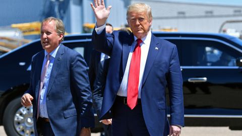 US President Donald Trump waves upon arrival, alongside Attorney General of Texas Ken Paxton (L) in Dallas, Texas, on June 11, 2020. (Photo by Nicholas Kamm / AFP) (Photo by NICHOLAS KAMM/AFP via Getty Images)