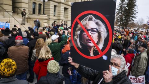A man holds up a sign against Rep. Liz Cheney (R-WY) as Rep. Matt Gaetz (R-FL) speaks to a crowd during a rally against her on January 28, 2021 in Cheyenne, Wyoming. (Photo by Michael Ciaglo/Getty Images)